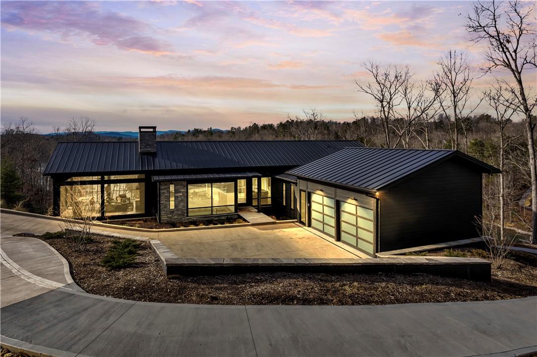 Image 3: This sleek modern home features expansive windows