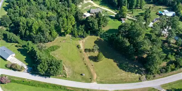 Image 3: Mature woodlands border rural acreage.