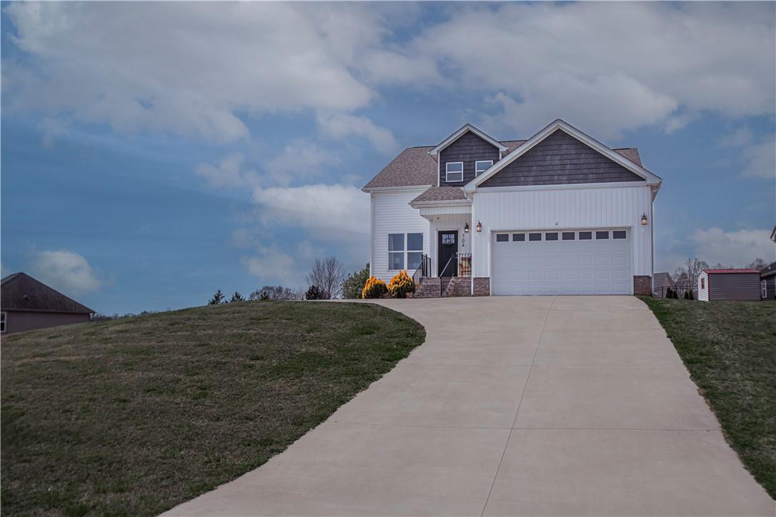 Image 2: This appealing two-story home features a classic d