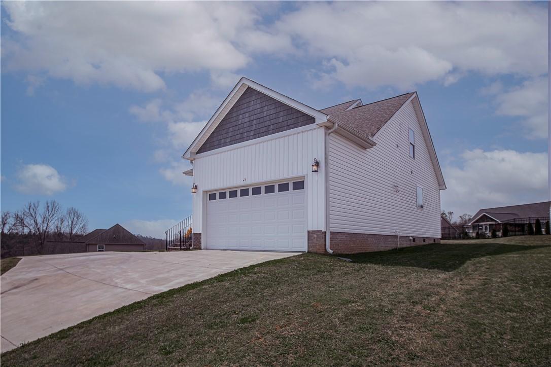 Image 3: This new construction features a spacious garage w