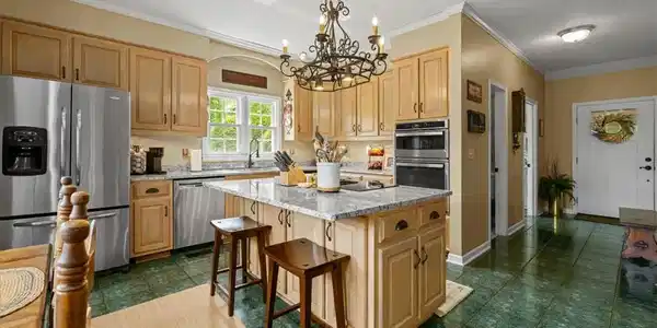 Image 2: This spacious kitchen offers a central island and
