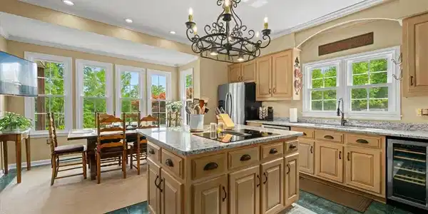 Image 3: An inviting kitchen with bright windows offers a p