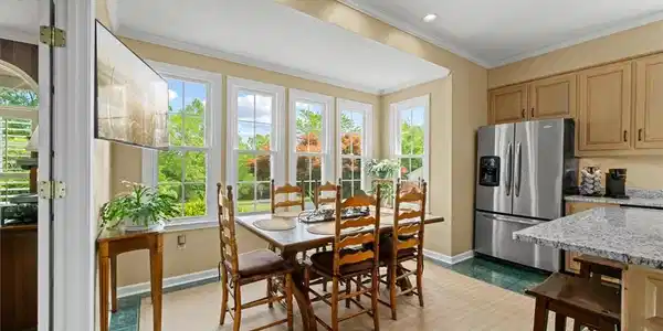 Image 4: This bright kitchen and dining area features abund