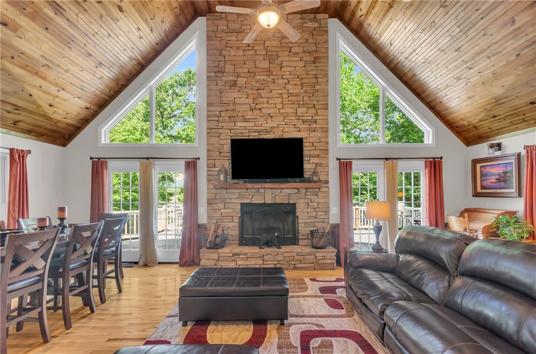 Image 3: A spacious living area features a grand stone fire