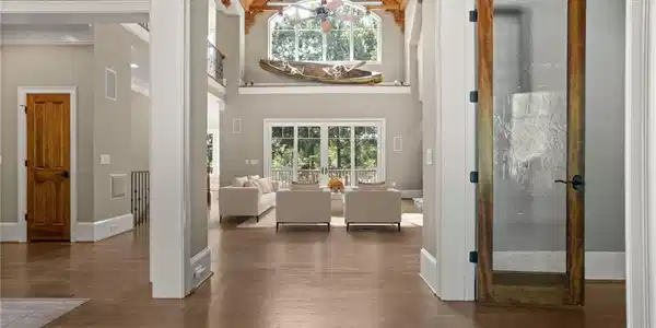 Image 3: Gleaming hardwood floors and a vaulted, beamed cei