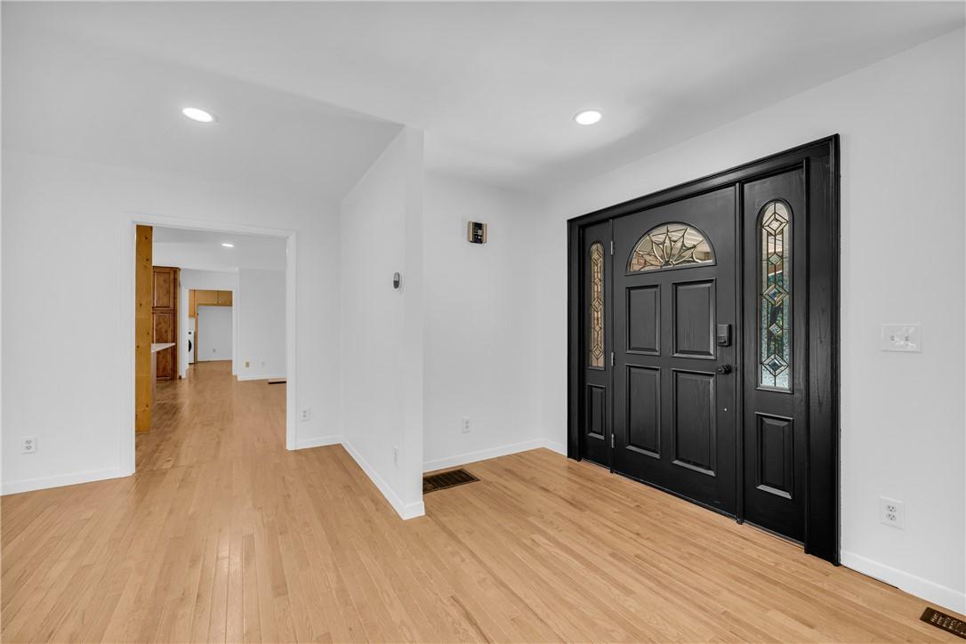 Image 4: A dark, ornate front door with decorative glass pa