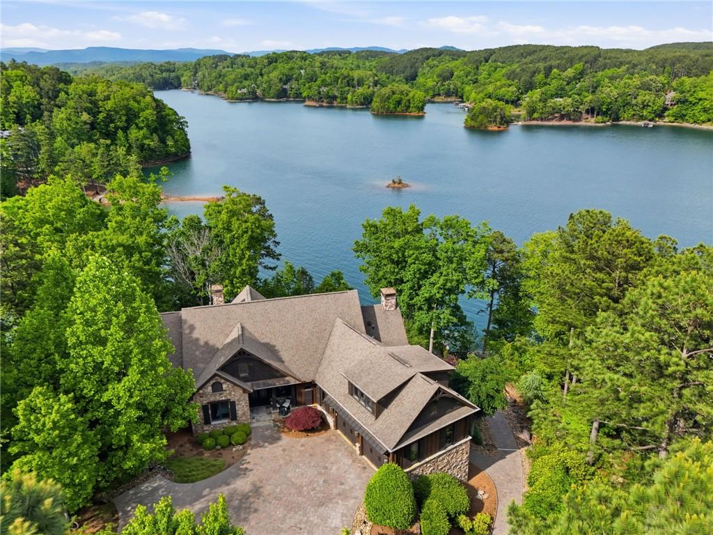 Image 1: Perched above a tranquil lake, this expansive resi