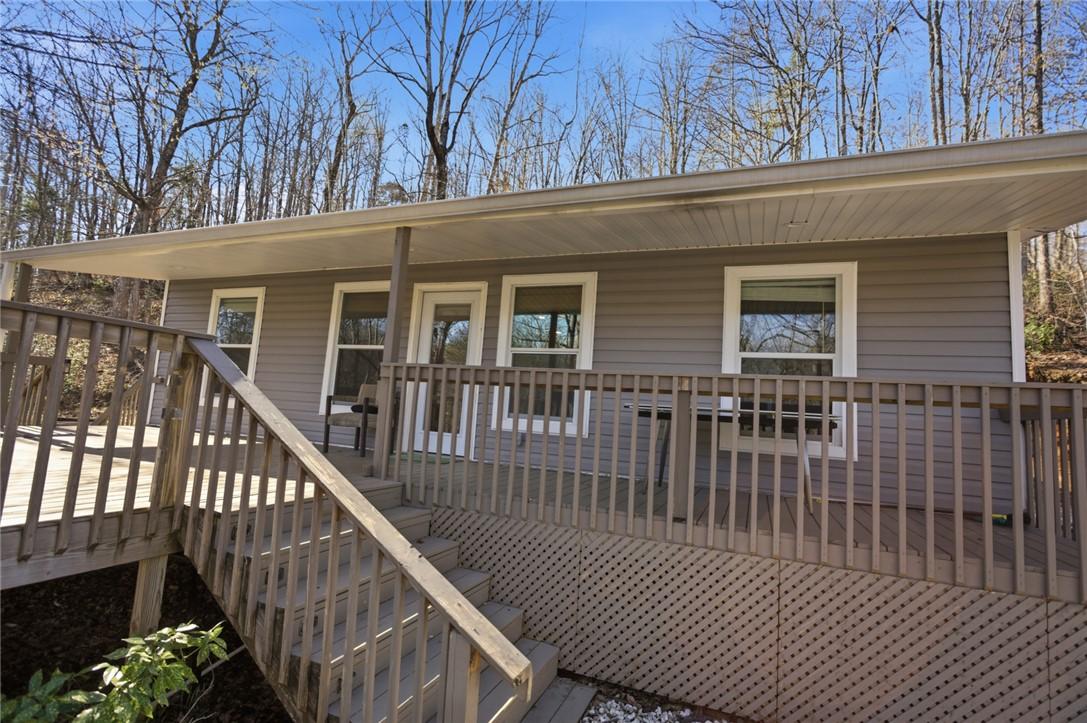 Image 2: This charming home features a spacious deck, perfe