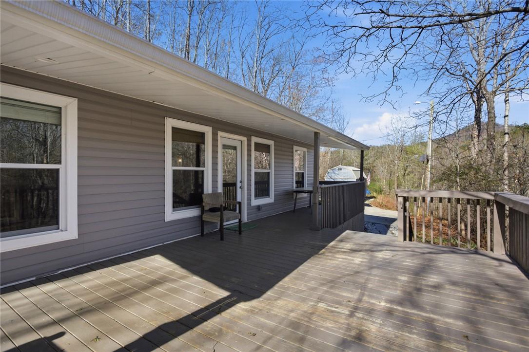 Image 4: This spacious wooden deck offers serene views and