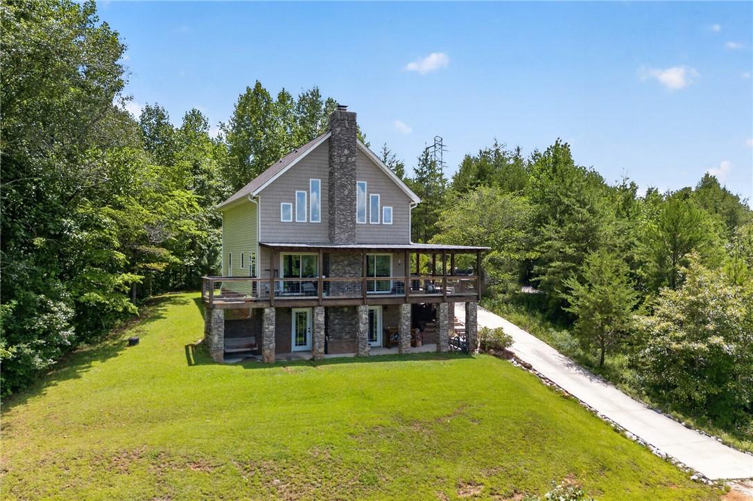 Image 1: Perched on a verdant hillside, this residence feat