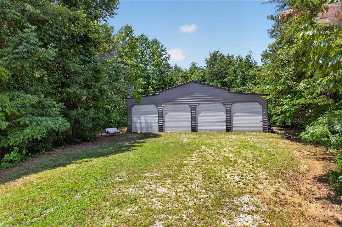 Image 3: A spacious, multi-bay garage offers ample storage