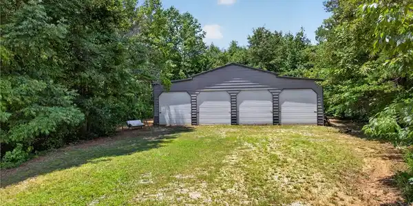Image 3: A spacious, multi-bay garage offers ample storage