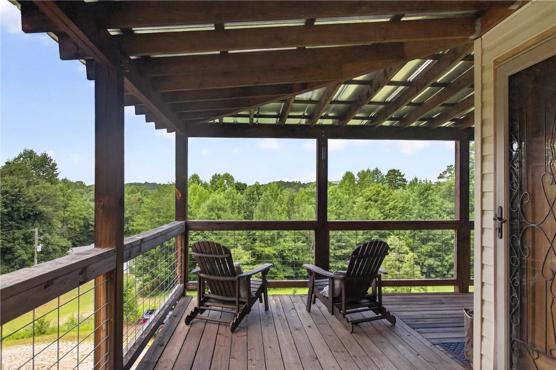 Image 4: A sheltered wooden deck provides a serene outdoor