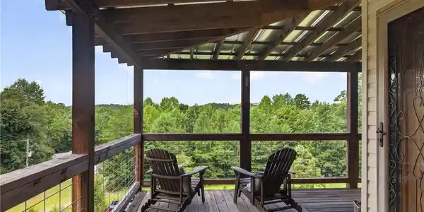 Image 4: A sheltered wooden deck provides a serene outdoor