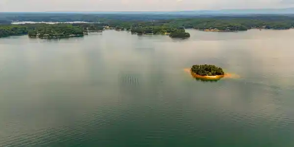 Image 4: An aerial panorama reveals a vast, serene lake dot
