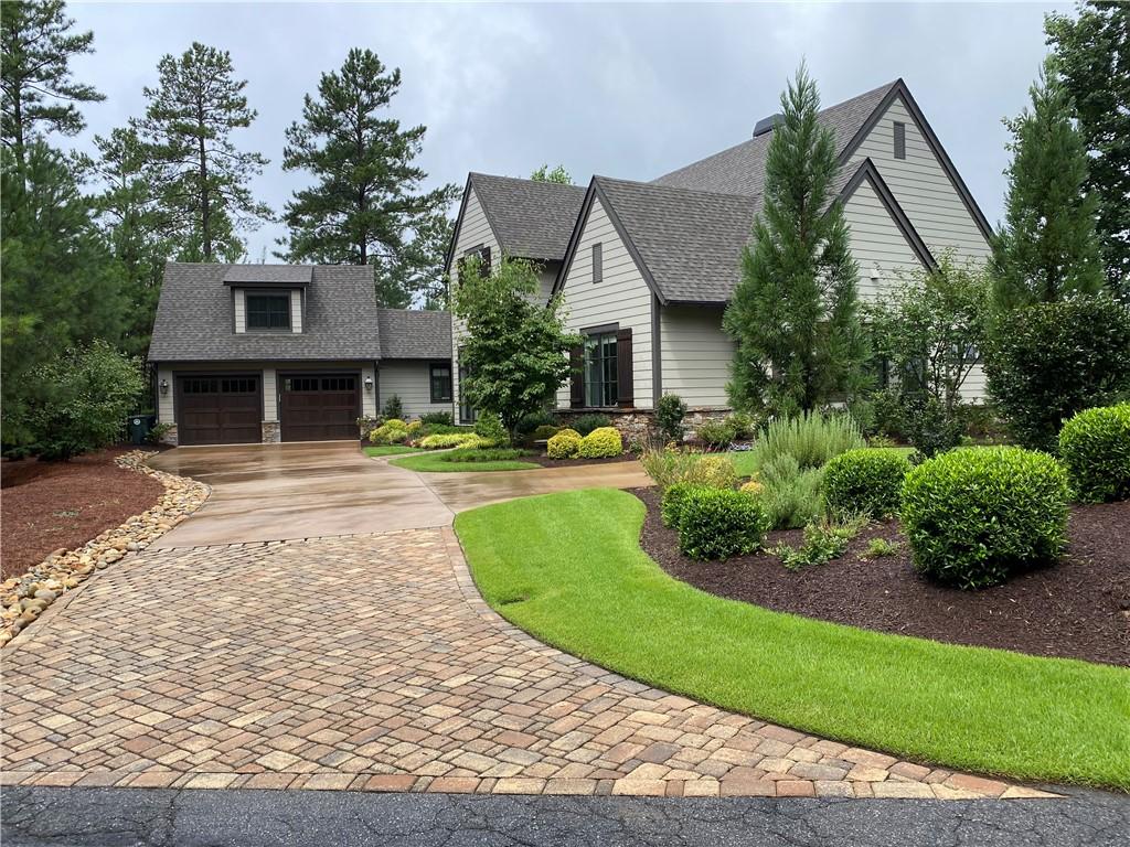 Image 3: This charming residence features a well-manicured