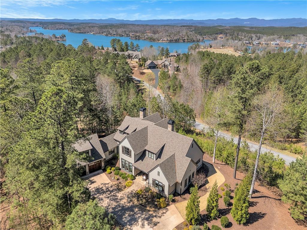 Image 4: Perched above a tranquil lake, this expansive resi