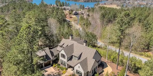 Image 4: Perched above a tranquil lake, this expansive resi
