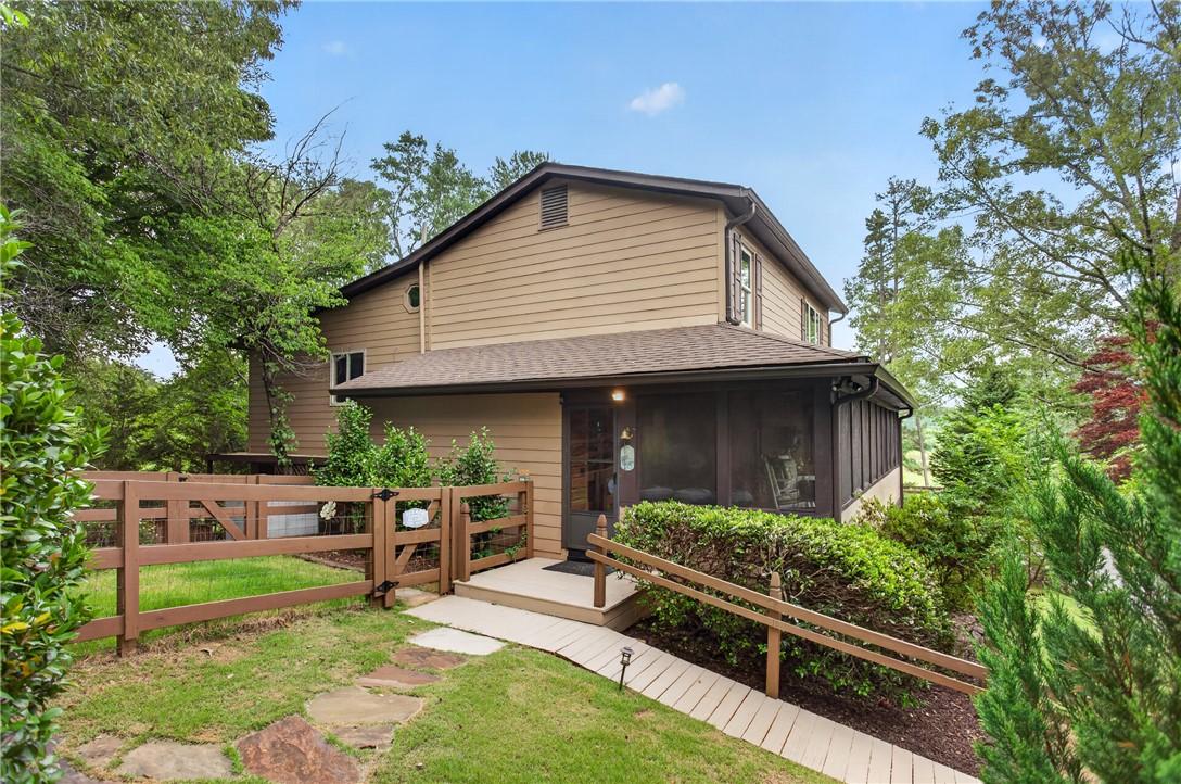 Image 2: A charming residence with inviting screened porch,