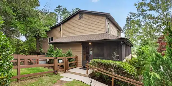 Image 2: A charming residence with inviting screened porch,