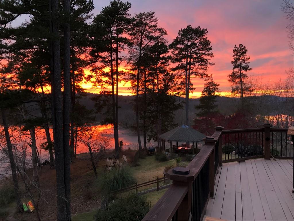 Image 4: A vibrant sunset over tranquil Lake Hartwell provi