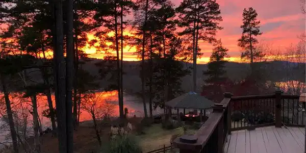 Image 4: A vibrant sunset over tranquil Lake Hartwell provi