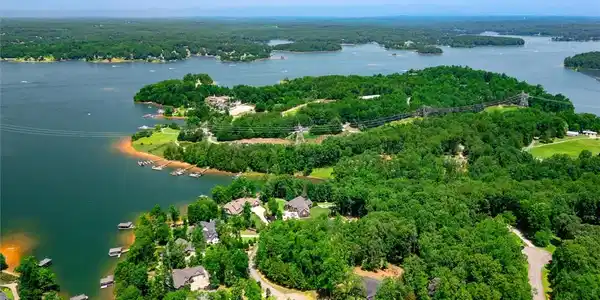 Image 4: An aerial panorama reveals verdant lakefront prope