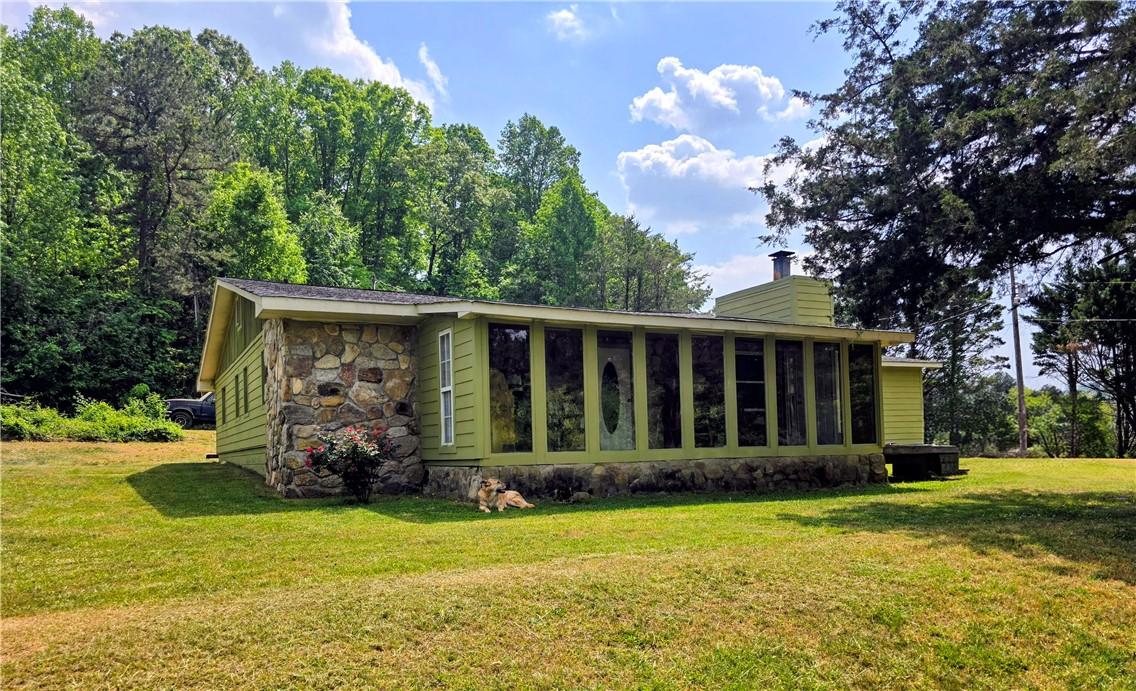 Image 1: A charming rustic retreat with stone accents and a