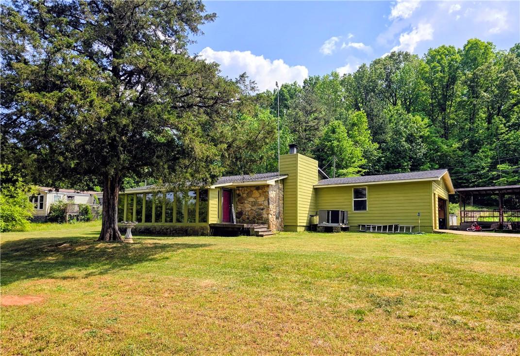 Image 2: A verdant hillside retreat, this residence boasts