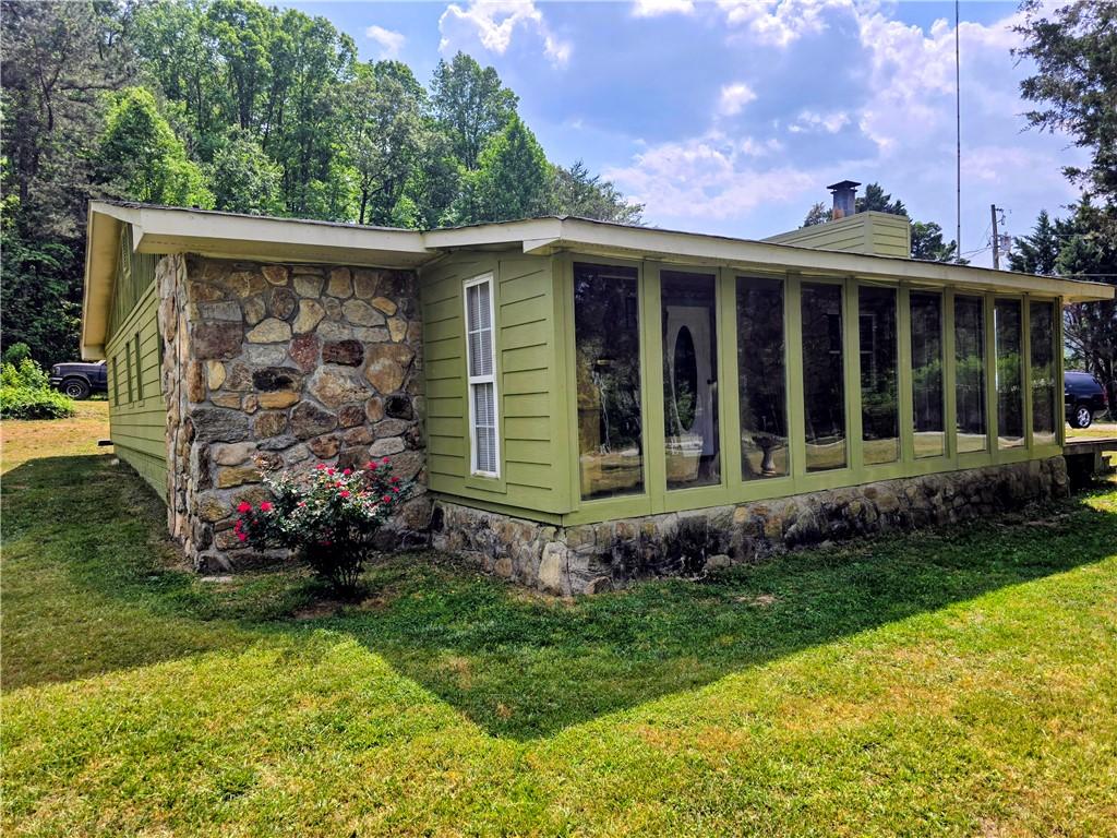 Image 3: A stone and siding exterior offers rustic appeal a