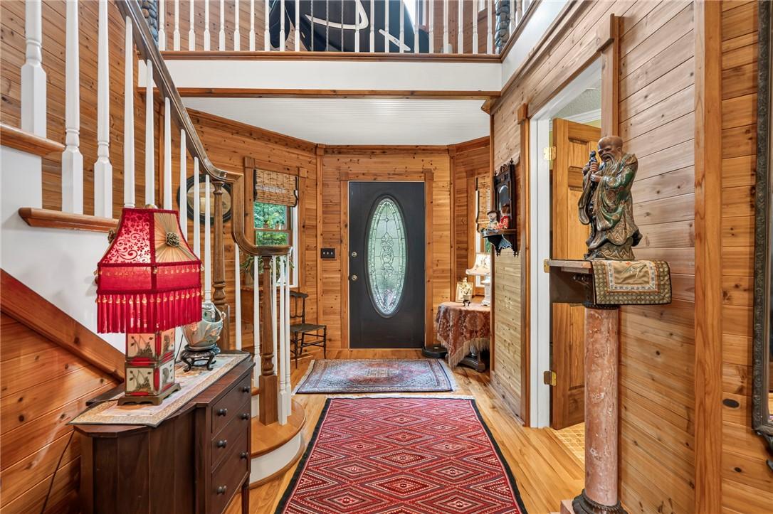 Image 2: A warm, inviting entry features extensive wood pan