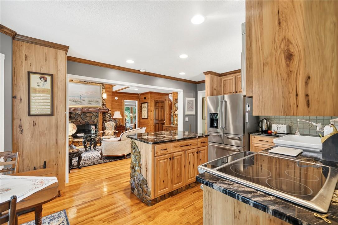 Image 4: An inviting kitchen with rich wood cabinetry and s