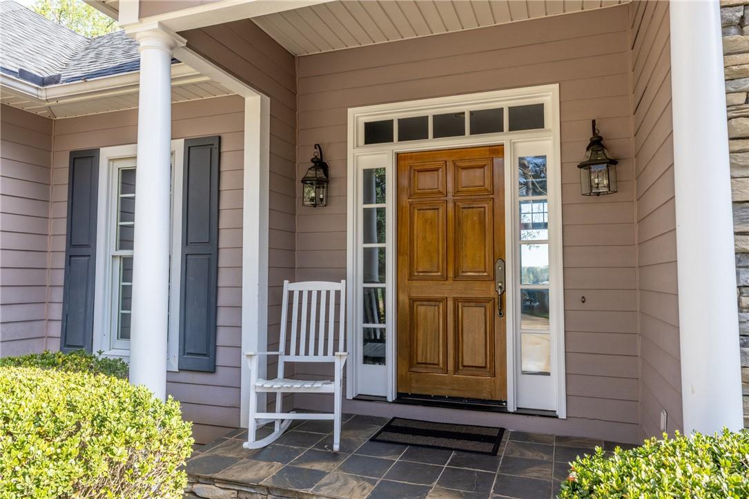 Image 3: This charming front entrance features a classic wo