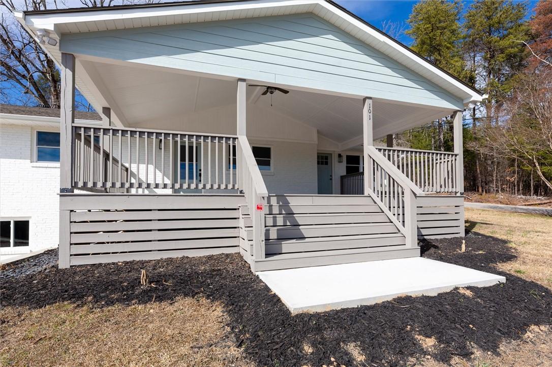 Image 1: This charming residence features a welcoming cover