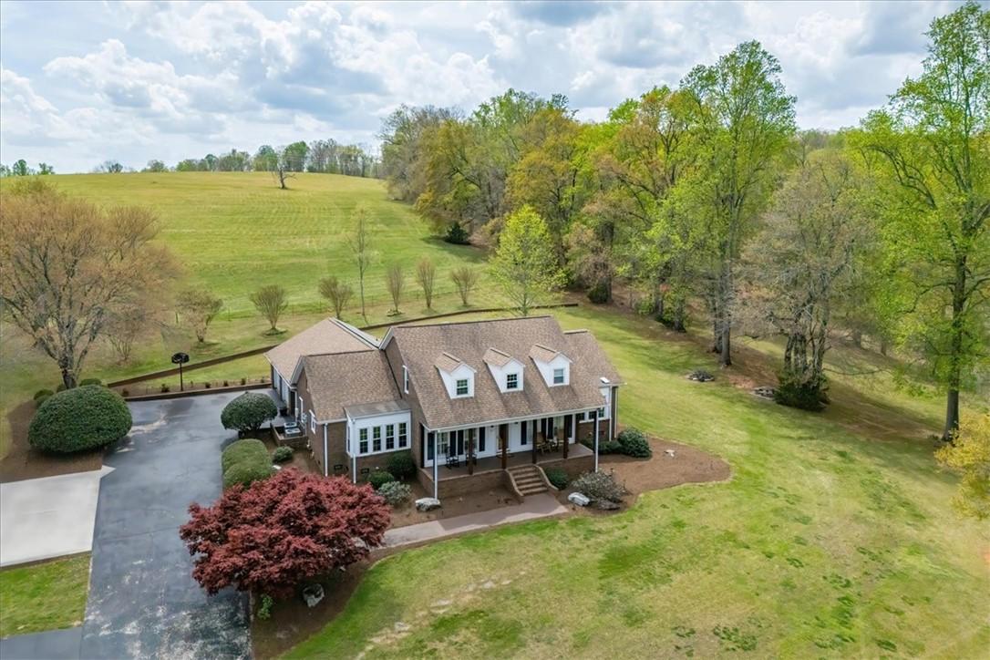 Image 1: This expansive estate features a charming residenc