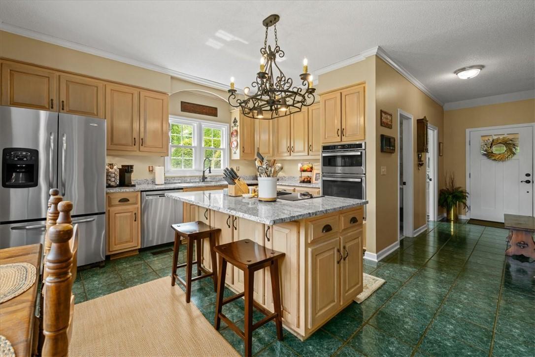 Image 2: This spacious kitchen offers a central island and