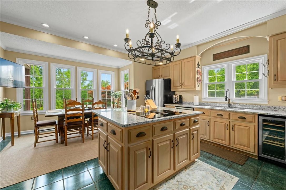 Image 3: An inviting kitchen with bright windows offers a p