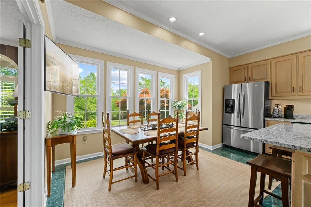Image 4: This bright kitchen and dining area features abund
