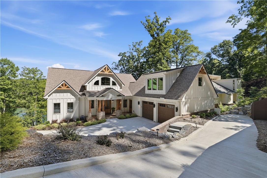 Image 1: Crafted with board and batten siding, this contemp