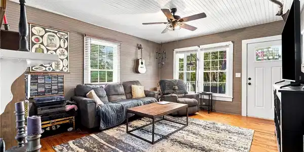Image 4: Rich hardwood flooring complements the distinctive
