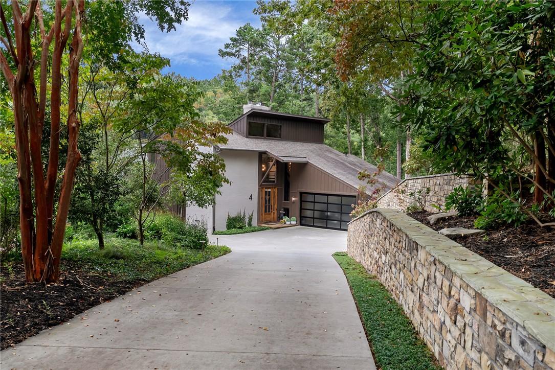 Image 1: Flat driveway leading to renovated home