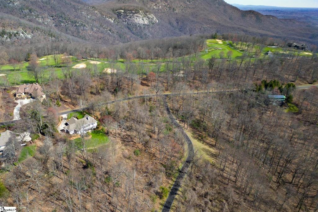 Image 4: An aerial panorama reveals a vast, wooded property