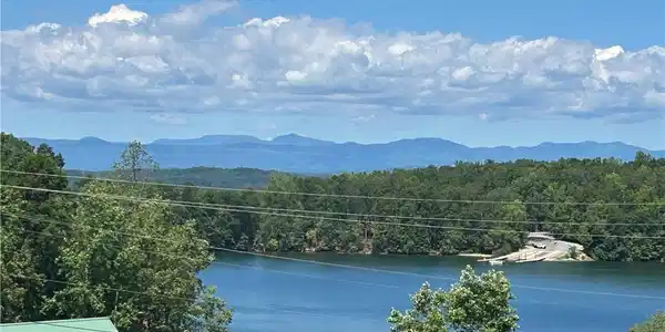 Image 2: Scenic lake vistas with distant mountains create a