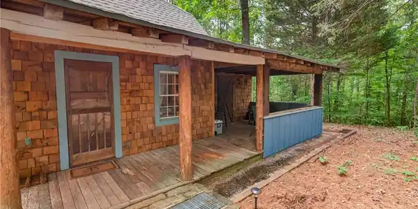 Image 3: A charming rustic retreat with a covered front por