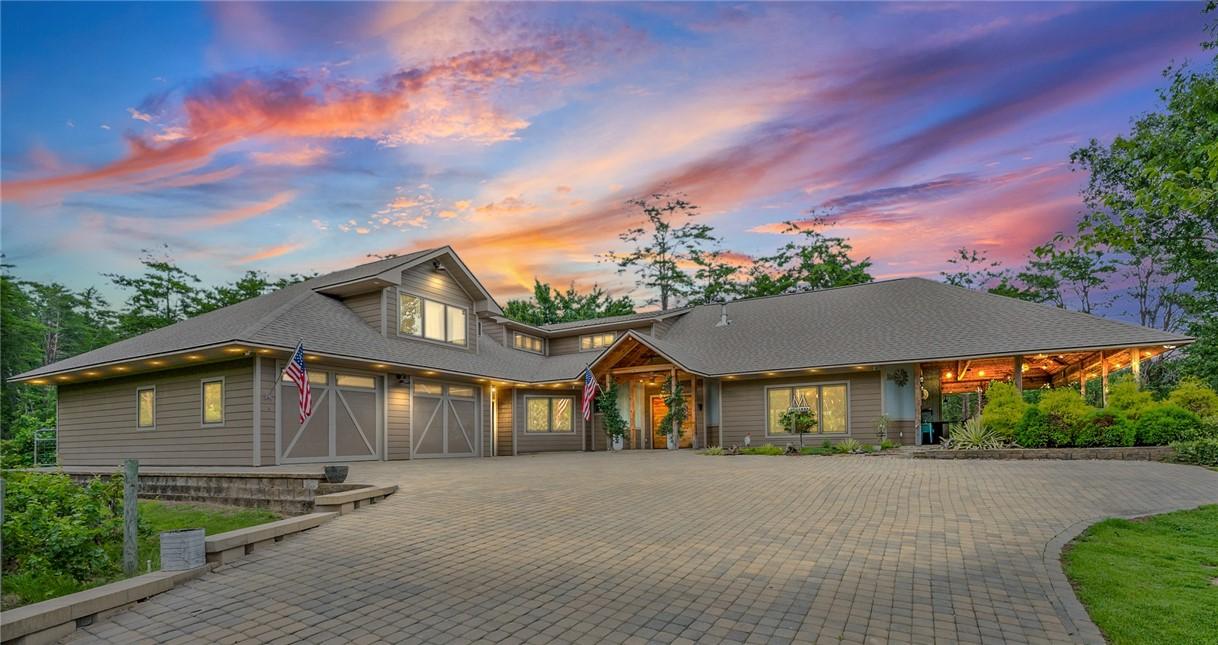 Image 1: A grand fa&ccedil;ade with an expansive paver driveway we