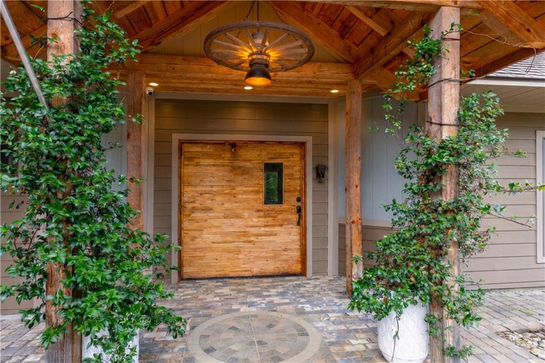 Image 2: A rustic entry welcomes with a wooden front door,