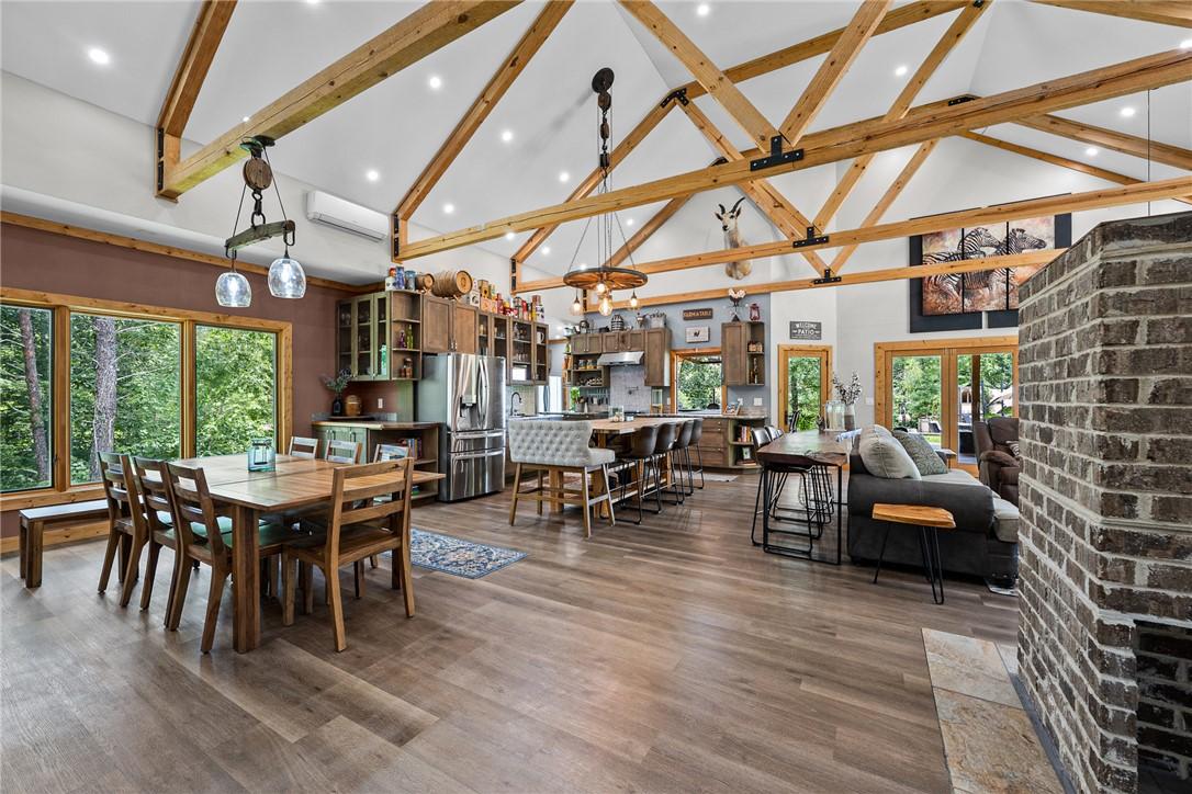Image 4: A spacious, open-concept living area with vaulted