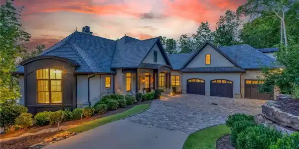 Image 3: A grand estate with a sweeping paved driveway, mul