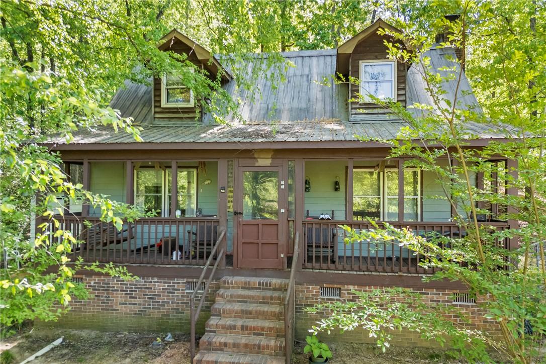 Image 1: This charming home offers a welcoming front porch,
