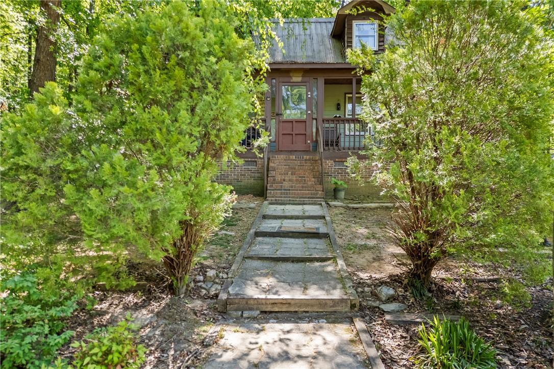 Image 3: This charming home offers a welcoming entrance sur